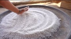 Preparation of traditional manioc flour flatbread in Ulupuwene, Upper Xingu region, Mato Grosso, Brazil.