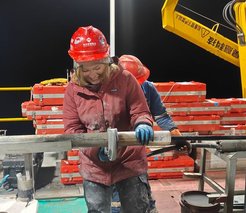 Olga Schmitz working on sediment cores on a floating platform during the International Continental Drilling Project NamCore on Lake Nam Co, Tibet. The core samples of sediment from the lake are expected to help understand past climate, with predicting future changes and its consequences on the continental-scale.